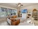 Comfortable living room features a ceiling fan and sliding glass doors to an outdoor patio at 404 Hightower Dr, Debary, FL 32713
