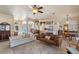 Bright living room with tile floors, ceiling fan, and neutral-toned furnishings at 404 Hightower Dr, Debary, FL 32713