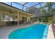 Inviting pool area featuring a screened enclosure and patio with dining and lounge spaces at 404 Hightower Dr, Debary, FL 32713