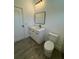 Clean bathroom featuring a modern vanity, toilet, and wood-look tile flooring at 1102 East Pkwy, Deland, FL 32724