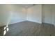 Well-lit bedroom with hard wood style floors and a closet door at 1102 East Pkwy, Deland, FL 32724