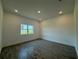 Empty bedroom with window and wood-look tile flooring at 1102 East Pkwy, Deland, FL 32724