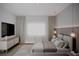 Relaxing bedroom with a light gray color scheme, modern furniture, and soft natural light at 1102 East Pkwy, Deland, FL 32724