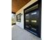 Welcoming entryway with modern black door and wood ceiling at 1102 East Pkwy, Deland, FL 32724