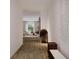 Bright hallway with wood floors that leads to a spacious living area with lots of natural light at 1102 East Pkwy, Deland, FL 32724