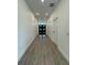 Long hallway with wood-look tile flooring leading to front door at 1102 East Pkwy, Deland, FL 32724