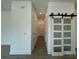 A hallway with luxury vinyl floors and a sliding glass door at 1102 East Pkwy, Deland, FL 32724