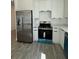Modern kitchen featuring stainless steel refrigerator and oven at 1102 East Pkwy, Deland, FL 32724
