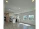 Modern kitchen area with white cabinets and island in an open-concept living space at 1102 East Pkwy, Deland, FL 32724