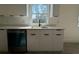 Bright kitchen view of white cabinets and stainless steel appliances at 1102 East Pkwy, Deland, FL 32724