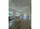 Bright, open-concept living area with a kitchen featuring a large island and tile flooring at 1102 East Pkwy, Deland, FL 32724