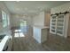 Open living area with sliding glass doors, modern kitchen with island, and sliding barn doors at 1102 East Pkwy, Deland, FL 32724