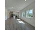 Spacious living room and kitchen with modern design, natural light, and sleek flooring at 1102 East Pkwy, Deland, FL 32724