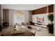 Open-concept living and dining area featuring stylish decor, modern lighting, and sleek entertainment center at 1102 East Pkwy, Deland, FL 32724