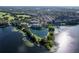 Aerial view of a lakeside community with a golf course, community pool, and walking paths at 3383 Westchester Square Blvd # 204, Orlando, FL 32835