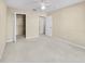 Spacious bedroom with closet and bathroom entrances; carpeted floor and neutral walls at 3383 Westchester Square Blvd # 204, Orlando, FL 32835