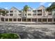 Three-story condo building with exterior balconies and stucco finish, offering a residence club, covered parking, and prime location at 3383 Westchester Square Blvd # 204, Orlando, FL 32835