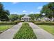 Community gazebo showcasing manicured green space with sidewalks, landscaping, and lush trees under a sunny sky at 3383 Westchester Square Blvd # 204, Orlando, FL 32835