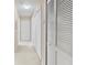 Hallway with neutral paint, carpet flooring, and multiple storage closets at 3383 Westchester Square Blvd # 204, Orlando, FL 32835