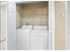 Bright laundry closet with washer, dryer and wire shelving for convenient storage at 3383 Westchester Square Blvd # 204, Orlando, FL 32835