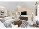Staged living room featuring modern furniture, decor, and a view of the dining area at 3383 Westchester Square Blvd # 204, Orlando, FL 32835