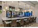 Upscale bar area with stylish seating, modern lighting, and multiple TVs at 8924 Adriatico Ln, Kissimmee, FL 34747