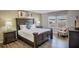 Well-appointed bedroom featuring a king bed, coordinated decor, and a view of neighborhood at 8924 Adriatico Ln, Kissimmee, FL 34747