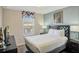 This is a bedroom with a queen size bed, a window, a nightstand, and a lamp at 8924 Adriatico Ln, Kissimmee, FL 34747