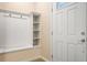 A home's entryway with a white door, beige walls, and custom built in shelving at 8924 Adriatico Ln, Kissimmee, FL 34747
