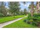 Beautiful landscaped grounds with lush greenery and manicured lawns and trees at 8924 Adriatico Ln, Kissimmee, FL 34747