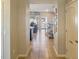 Inviting hallway leads to living spaces, featuring tile flooring and staircase access at 8924 Adriatico Ln, Kissimmee, FL 34747