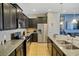 Modern kitchen featuring stainless steel appliances, granite countertops, and tile flooring at 8924 Adriatico Ln, Kissimmee, FL 34747