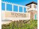 Windsor at Westside community sign featuring stone accents and manicured landscaping at 8924 Adriatico Ln, Kissimmee, FL 34747