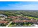 Apartment community aerial view showcasing central pond, lush trees, and well-kept grounds at 5530 Metrowest Blvd # 9-211, Orlando, FL 32811
