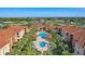 Overhead view highlighting the community's amenities, including pools and verdant landscaping at 5530 Metrowest Blvd # 9-211, Orlando, FL 32811