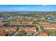 Expansive aerial perspective of a community set against a backdrop of lakes and roadways at 5530 Metrowest Blvd # 9-211, Orlando, FL 32811