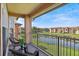 Balcony with two chairs overlooking a pond and surrounding community at 5530 Metrowest Blvd # 9-211, Orlando, FL 32811