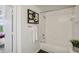 Bright bathroom featuring a tub and shower with white tiling, plus a decorative wall print at 5530 Metrowest Blvd # 9-211, Orlando, FL 32811