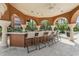 Enjoy outdoor dining and entertaining with this bar area that features seating for six and beautiful stone columns at 5530 Metrowest Blvd # 9-211, Orlando, FL 32811