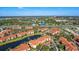 Scenic aerial view of the community with beautiful lake, manicured lawns and landscaping under a clear blue sky at 5530 Metrowest Blvd # 9-311, Orlando, FL 32811