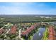 A high vantage point exhibiting a serene pond bordered by mediterranean apartments with thick wooded boundaries at 5530 Metrowest Blvd # 9-311, Orlando, FL 32811