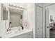 Clean bathroom featuring a single vanity, decorative mirror, and coordinated decor at 5530 Metrowest Blvd # 9-311, Orlando, FL 32811