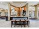 Modern kitchen featuring a breakfast bar with seating, granite countertops, and stainless steel appliances at 5530 Metrowest Blvd # 9-311, Orlando, FL 32811