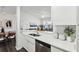 Modern kitchen featuring stainless steel appliances, white cabinetry, and view of the living room at 5530 Metrowest Blvd # 9-311, Orlando, FL 32811
