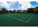Well-maintained tennis court for active recreation in a vibrant community setting, with lush trees and blue skies overhead at 6451 Old Park Ln # 110, Orlando, FL 32835