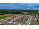 Aerial view of a neighborhood with houses and greenery surrounding at 6646 Rhythm Dr, Mascotte, FL 34753