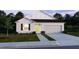 Charming single-story home with a two-car garage, manicured lawn, and neutral color palette at 6646 Rhythm Dr, Mascotte, FL 34753