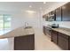 Modern kitchen featuring stainless steel appliances, granite countertops, and ample cabinet space at 6646 Rhythm Dr, Mascotte, FL 34753
