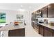 Modern kitchen featuring stainless steel appliances, granite countertops, and ample cabinet space at 6646 Rhythm Dr, Mascotte, FL 34753