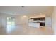 Spacious and open living area with abundant natural light, connecting kitchen, dining, and living room at 6646 Rhythm Dr, Mascotte, FL 34753